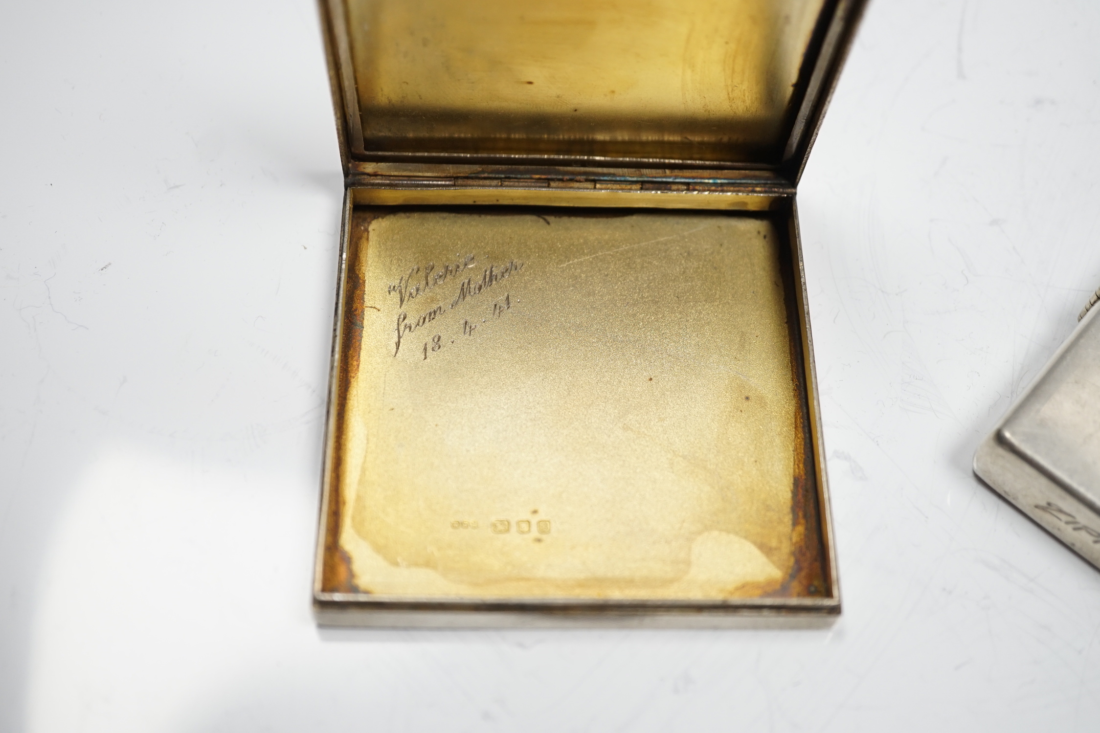 A sterling cased Zippo lighter, 71mm, together with a 1930's engine turned silver cigarette case.